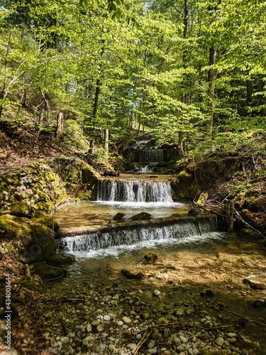 small river flows through the wooded valley above Wlad in zurich oberland, schmittenbach. nice little waterfall. swiss photo