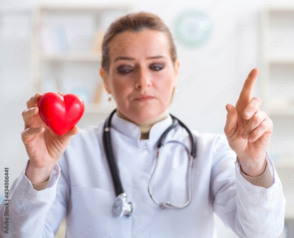 Cardiologist with red heart in medical concept Cardiologist with red heart in medical concept
