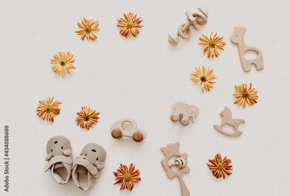 Newborn baby background. wooden toy with accessories for kids on beige background. Gender neutral. Organic and natural toys. Eco friendly plastic free toys for toddler. Ecology zero waste Newborn baby background. wooden toy with accessories for kids on beige background. Gender neutral. Organic and natural toys. Eco friendly plastic free toys for toddler. Ecology zero waste
