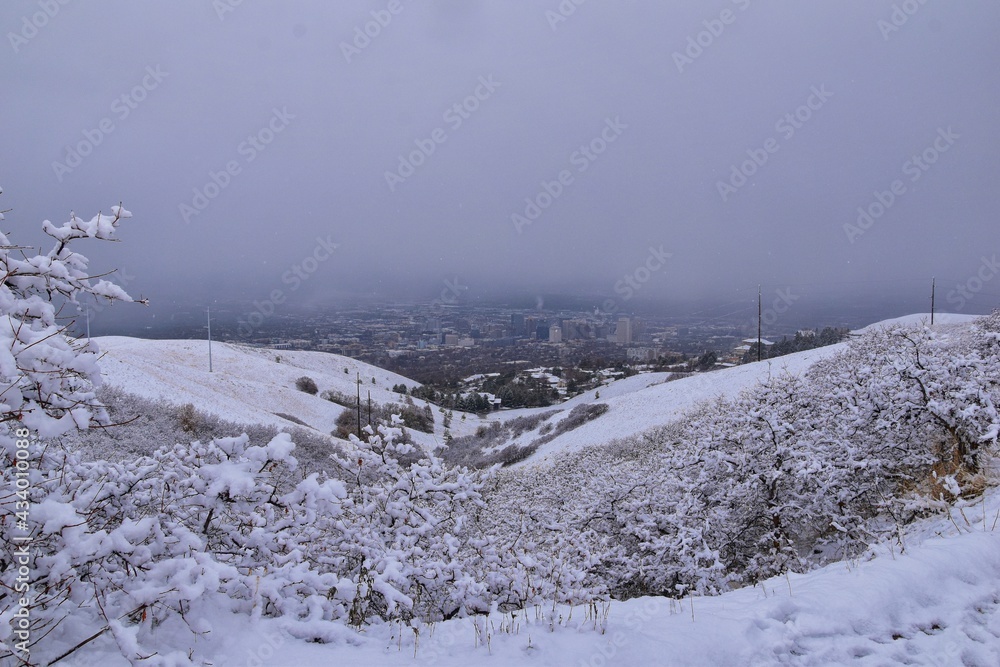Fototapeta premium Little Black Mountain Peak hiking trail snow views winter via Bonneville Shoreline Trail, Wasatch Front Rocky Mountains, by Salt Lake City, Utah. United States.