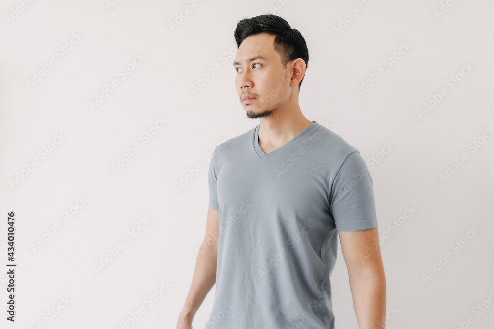 Normal portrait of an Asian man in a blue t-shirt isolated on white background. Normal portrait of an Asian man in a blue t-shirt isolated on white background.
