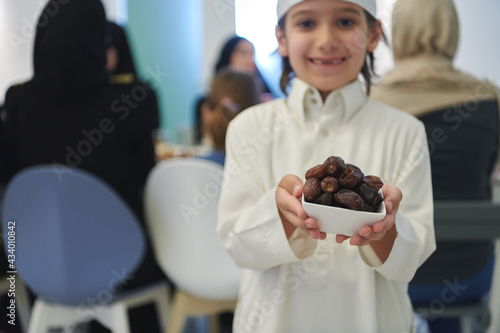Arabian kid in the traditional clothes during iftar