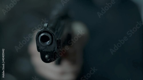young man raises the gun and pulls the trigger