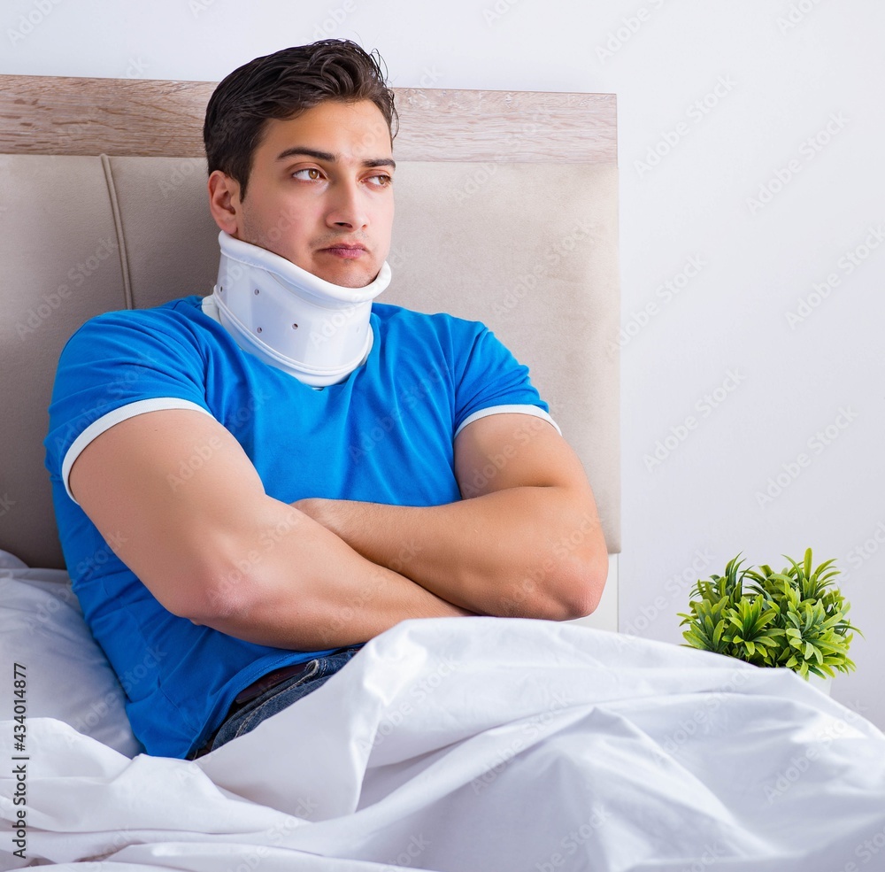 Young man with neck injury in the bed Young man with neck injury in the bed