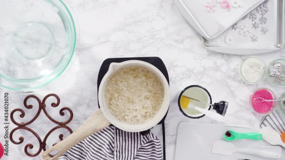 Flat lay. Step by step. Caramelizing sugar in a small cooking pot over the small electric stove. Flat lay. Step by step. Caramelizing sugar in a small cooking pot over the small electric stove.
