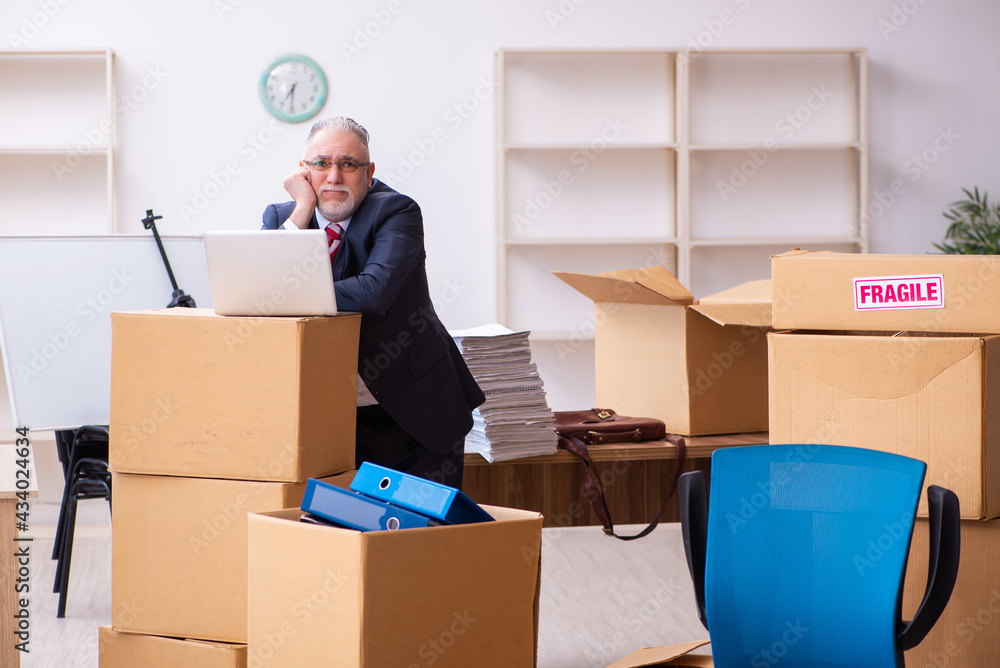 Old businessman employee in relocation concept Old businessman employee in relocation concept