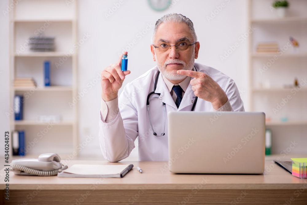 Old male doctor in vaccination concept Old male doctor in vaccination concept