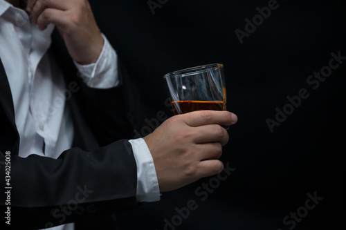 Closeup businessmen holding a glass of whiskey