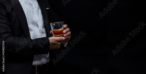 Closeup businessmen holding a glass of whiskey