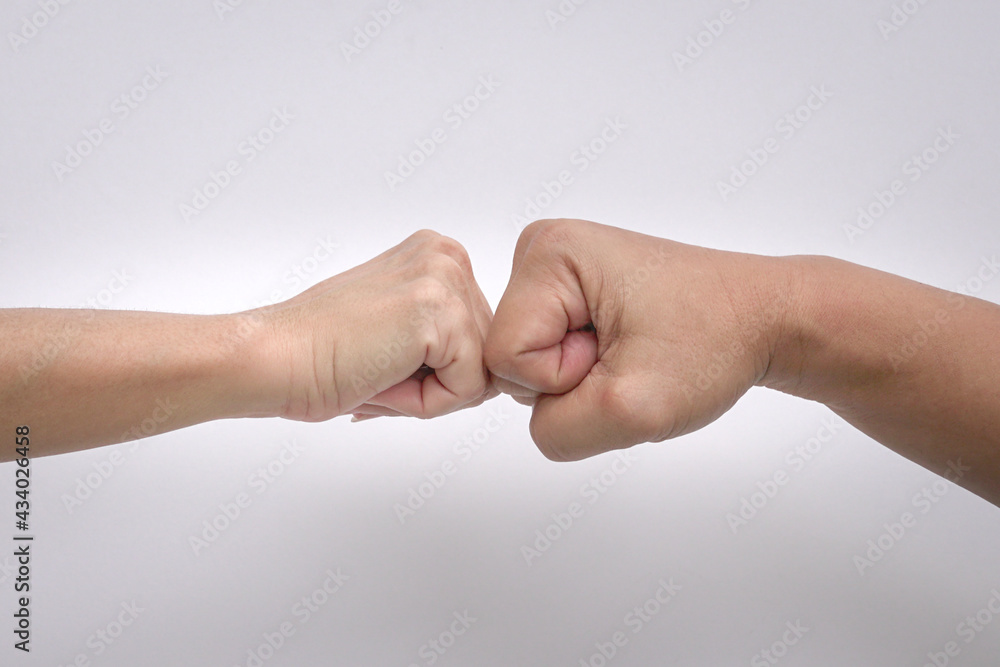 Close up shot of fist bump against white background.