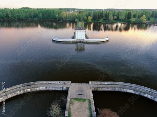 Aerial view sunset on the river. Colorful clouds are reflected in the water. Beautiful panorama of nature at sunset.