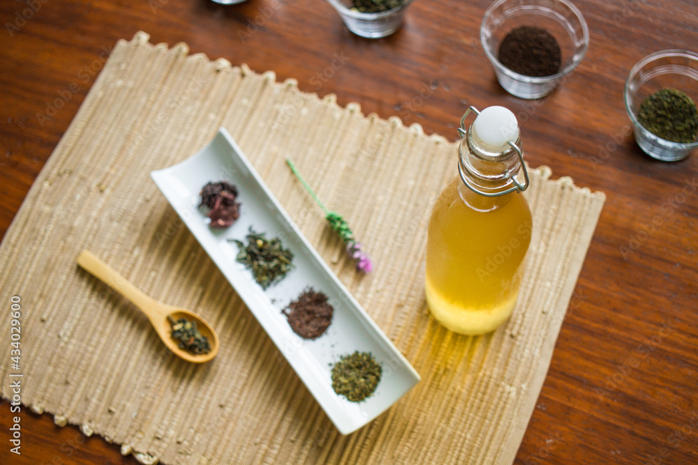 Spices, wooden table, and kombucha