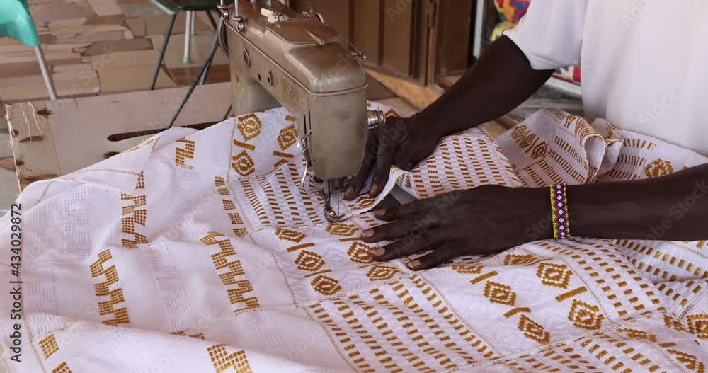 Sewing hand loom Kente cloth fabric Kumasi Ghana. A town in Ghana