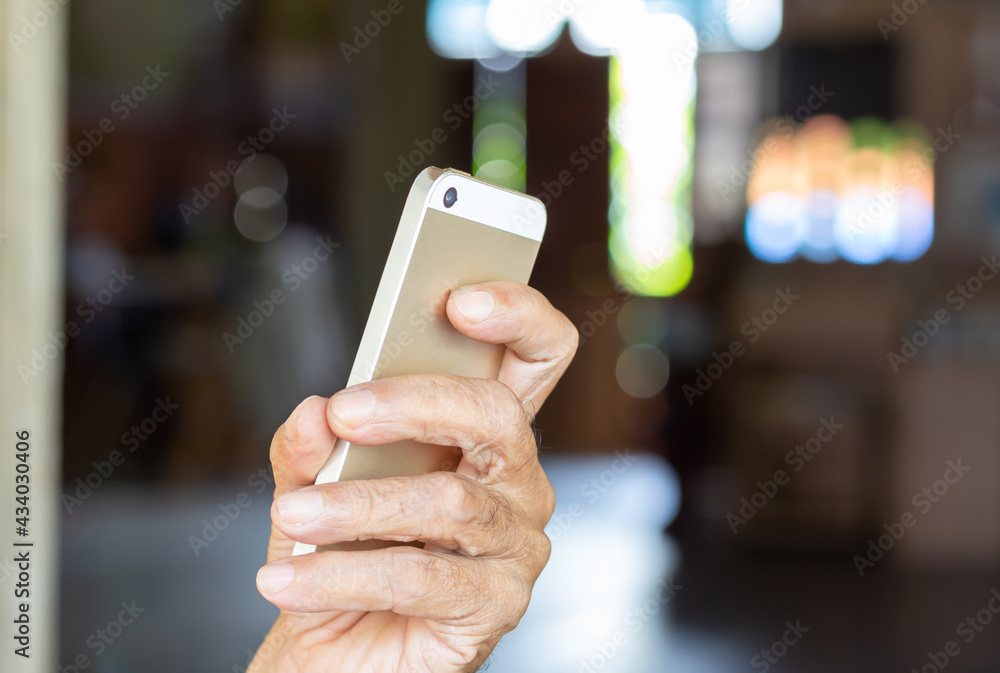 Man holding smart phone with blurred background Man holding smart phone with blurred background