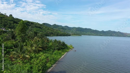 Aerial Lake Bosomtwe shore Kumasi Ghana Africa part 1. Only natural lake in Ghana. It is situated within an ancient impact crater. A sacred lake in traditional beliefs. Tourist resorts and fishing. photo