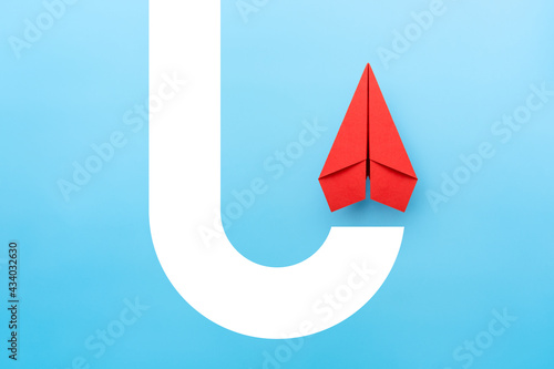 Economic recovery, growth and development with red paper plane flying up photo