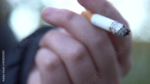 Cigarette Being Held In A Young Girls Hand