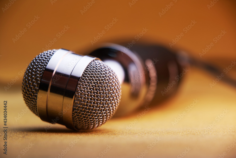 Obraz premium selective focus of vintage microphone on brown background