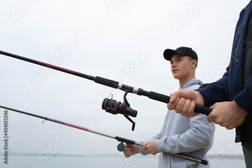 Father and son fishing toge...