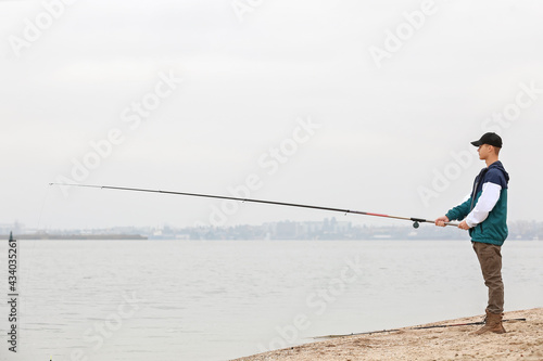 Teenage boy fishing on river