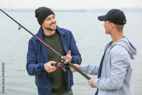Father and son fishing toge...