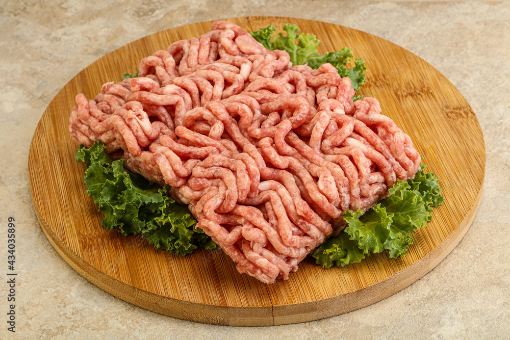 Raw pork minced meat over board Raw pork minced meat over board