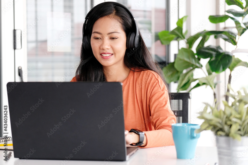 Work from home, Asian woman working with laptop computer at home, Asia female shopping online, Happy girl learning by internet, study online education, e commerce business Work from home, Asian woman working with laptop computer at home, Asia female shopping online, Happy girl learning by internet, study online education, e commerce business