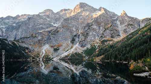 Fototapeta Naklejka Na Ścianę i Meble -  Wonderful morning view of the beautiful Lake Morskie Oko in the High Tatra Mountains. Rocks with forests are reflected in the water. Natural beauty.