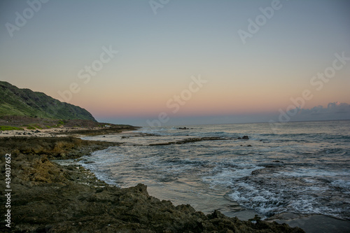 sunset over the rocky shoreline