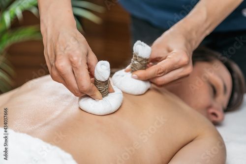 Tableau sur toile Ayurvedic Massage with Kizhi or Herbal Bags at Wellness Center