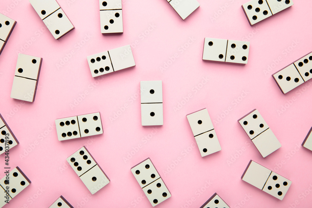 Domino pieces on the pink background. Macro photo Domino pieces on the pink background. Macro photo