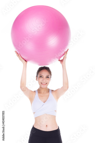 Young asian sporty woman with pink fit ball isolate on white background .
