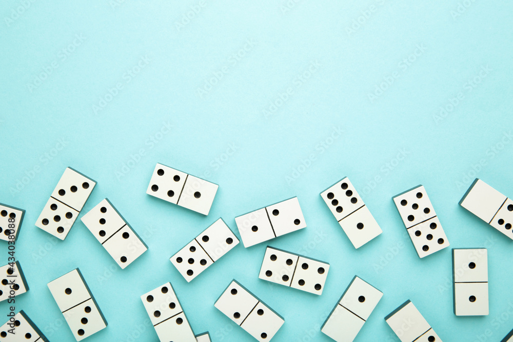 Domino pieces on the blue background with copy space Domino pieces on the blue background with copy space