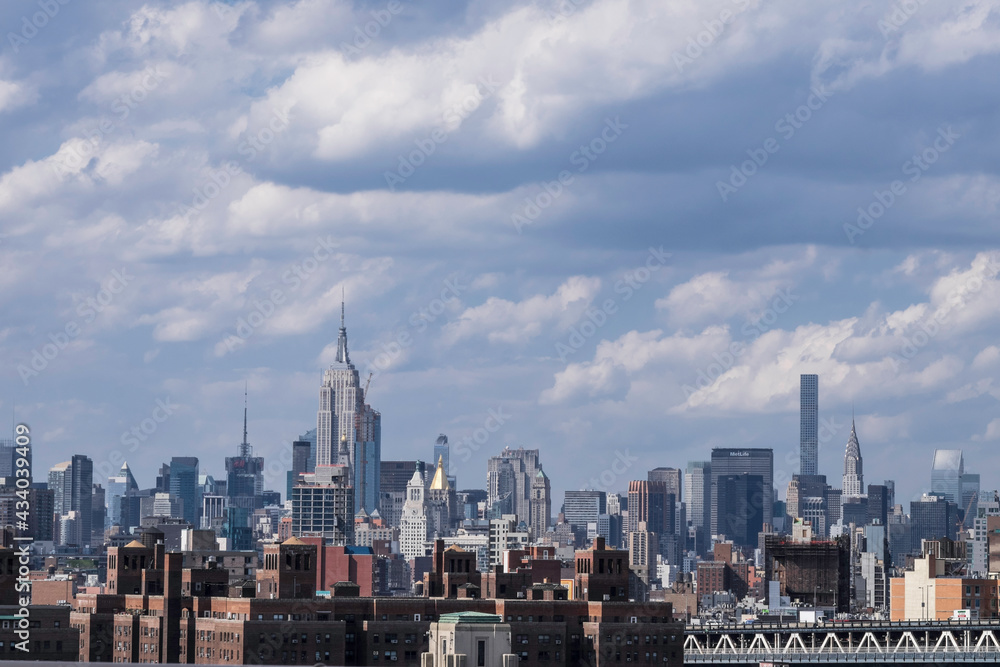 Fototapeta premium New York City skyline with clouds taken from Brooklyn bridge. Place fot text on sky