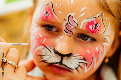 Wallpaper Mural little girl having her face painted for kids party. Halloween or carnival family lifestyle Face painting, headshot close up Torontodigital.ca