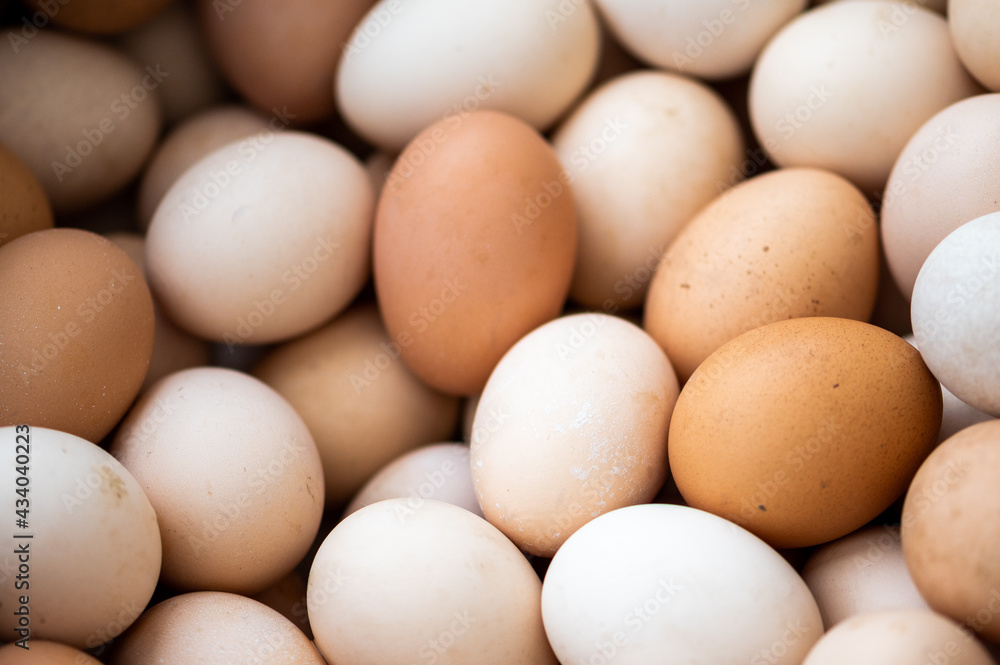 Closeup of many organic eggs with visible dirt on them