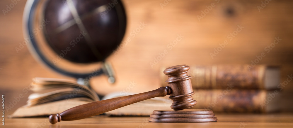 Law and justice concept, wooden gavel, globe background Law and justice concept, wooden gavel, globe background