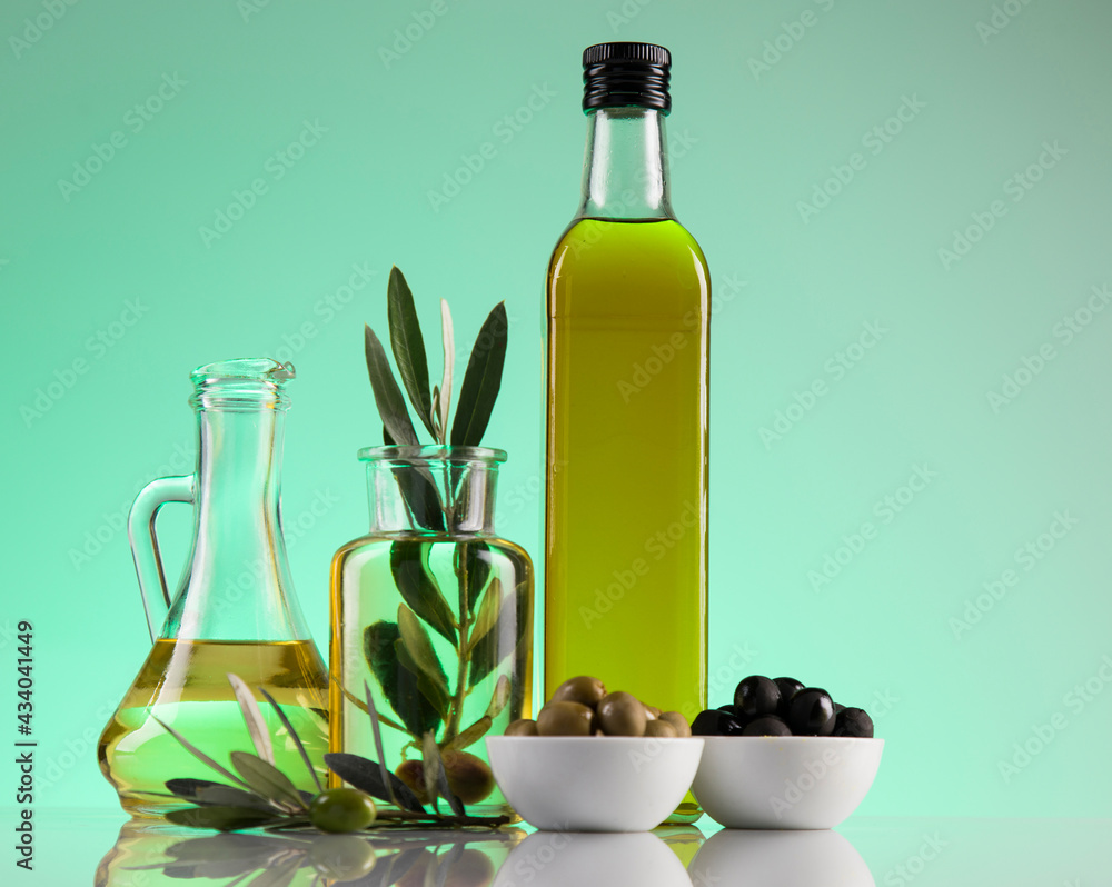 Bottles of olive oil, olive branch and Cooking oils Bottles of olive oil, olive branch and Cooking oils