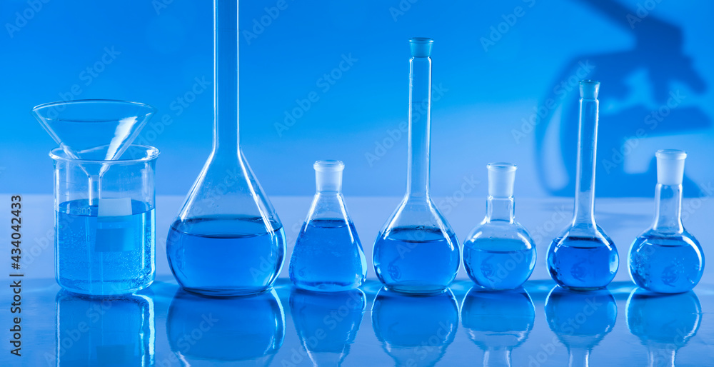 Laboratory beakers,Science experiment, blue background Laboratory beakers,Science experiment, blue background