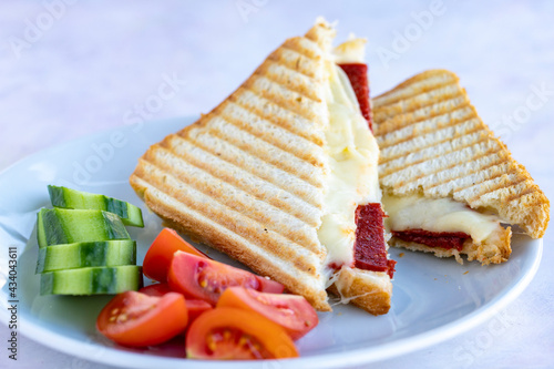 sausage and cheese toast, tomato and cucumber. photo