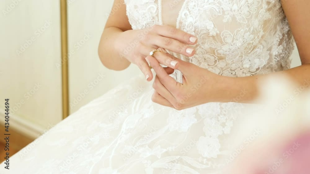 Close up of bride hand putting wedding ring on her finger
Close up of bride hand putting wedding ring on her finger