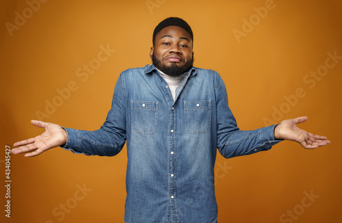 Fotografie Young african american man shrugging his shoulders, he doesn't know