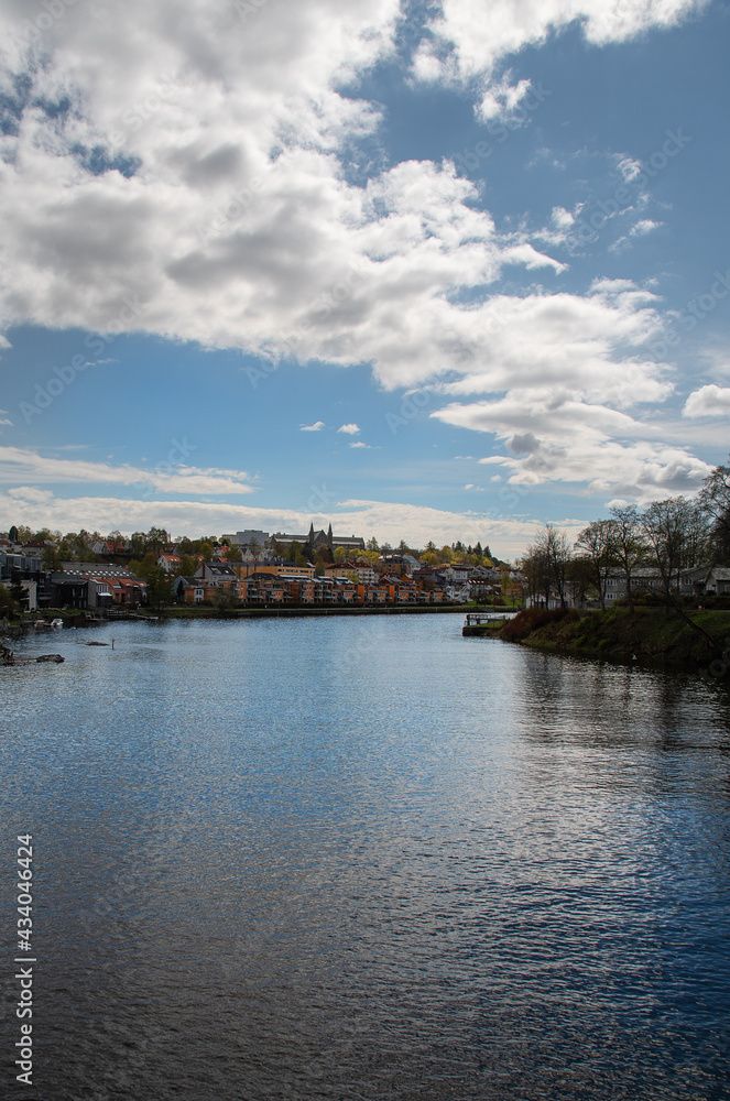 View of Trondheim with NTNU (Technical College) in the background the river Nidelva silently floats in the foreground. Vertical photo.