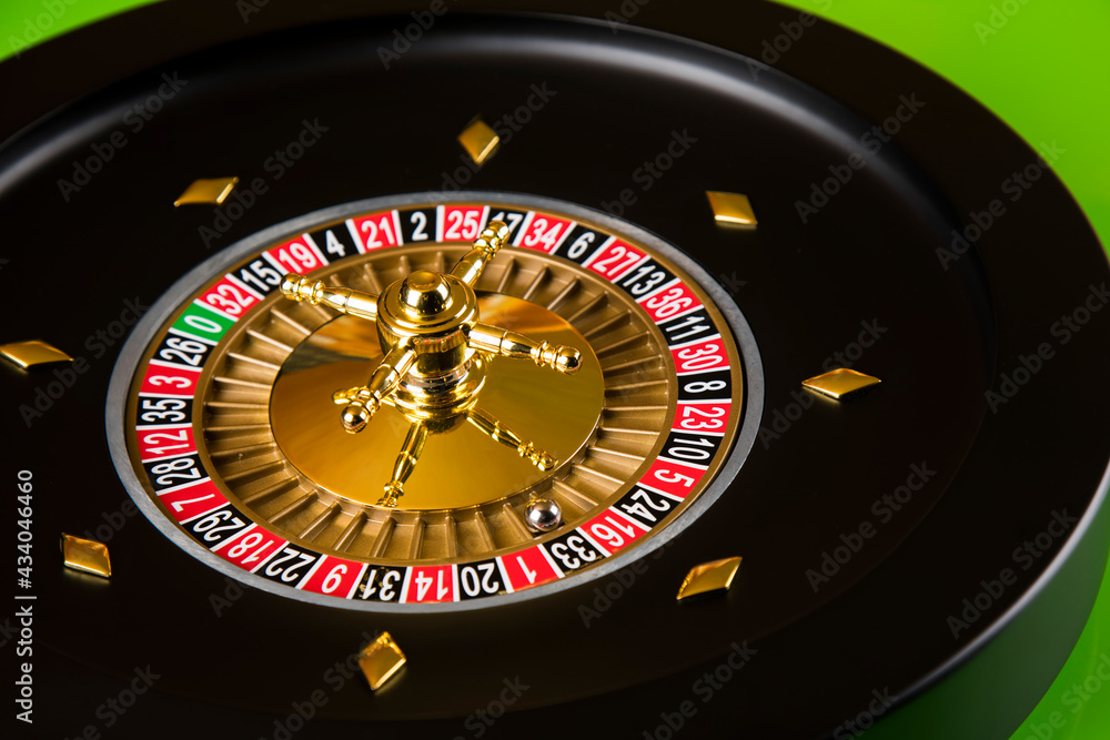 Roulette wheel in motion in a casino background Roulette wheel in motion in a casino background