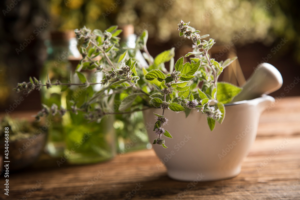 Natural remedy and mortar, healing herbs background Natural remedy and mortar, healing herbs background