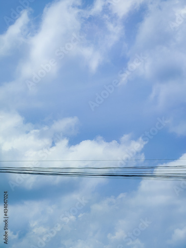 Electric cables in blue sky and beautiful clouds.