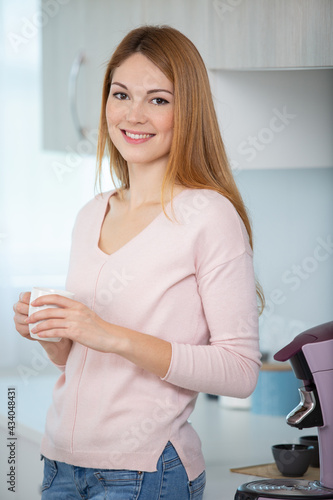 very tired looking woman drinking
