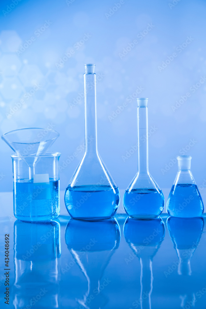 Laboratory beakers,Science experiment, blue background Laboratory beakers,Science experiment, blue background
