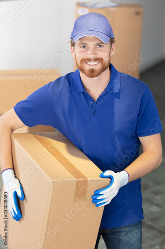 home delivery service - deliveryman with box standing photo