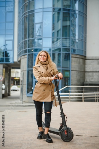 Portrait of a young woman with electro scooter